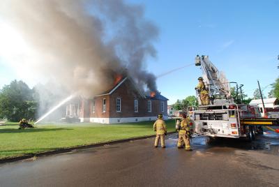water shooting toward burning house